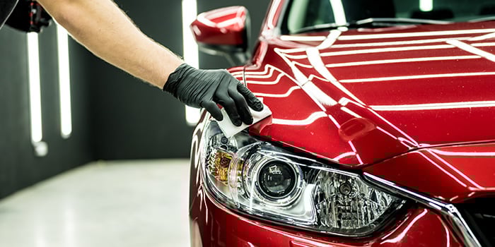 A clean shiny red vehicle in a car garage